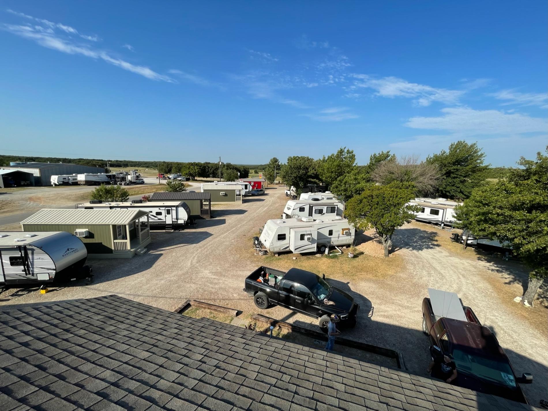 aerial view on a nice day where you can see the property and vehicles